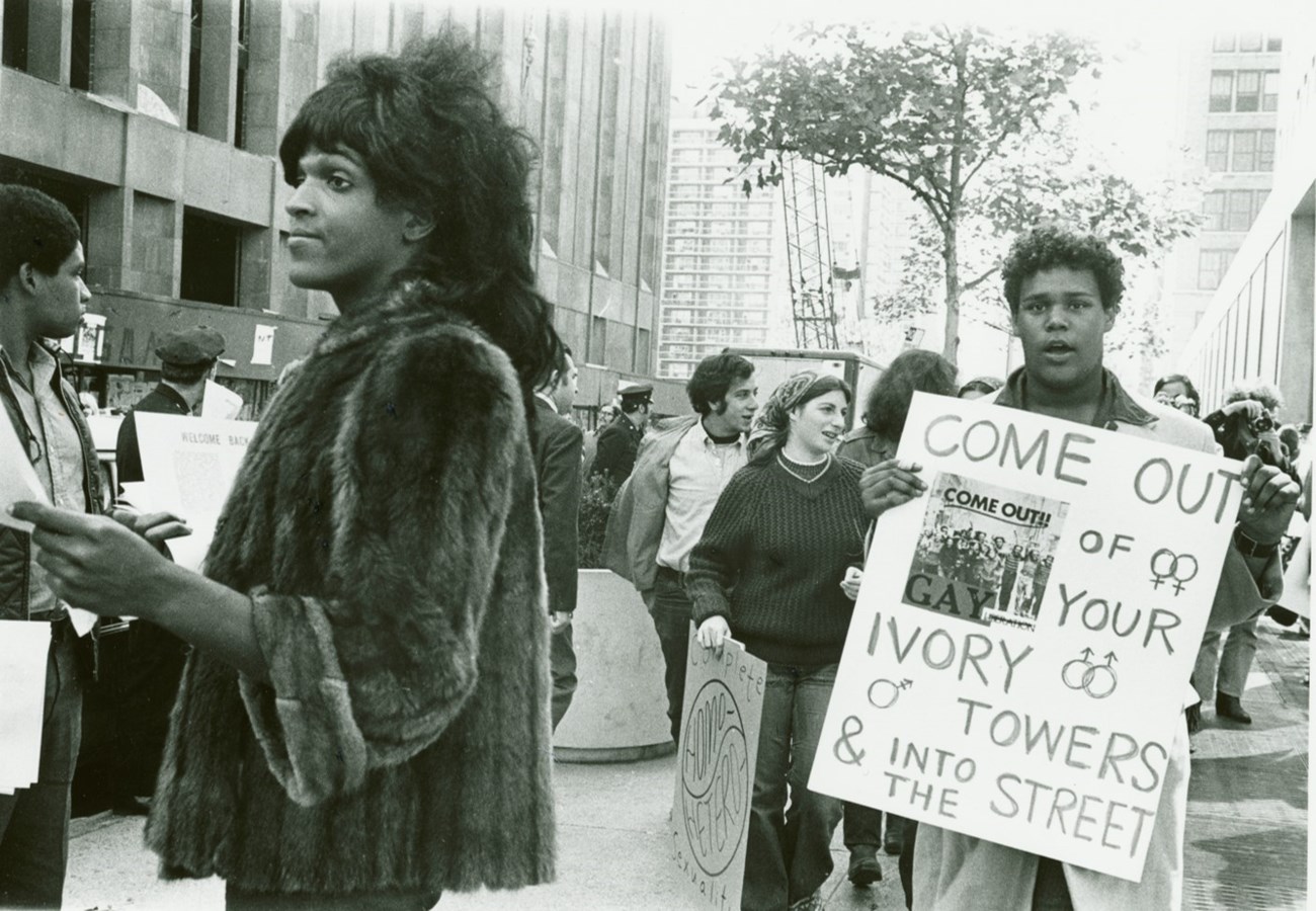 Marsha P. Johnson handing out flyers with NYC students in the background Marsha P. Johnson Hands Out Flyers in Support of Gay Students at N.Y.U., 1970